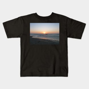 A lonely boat at sunset Kids T-Shirt